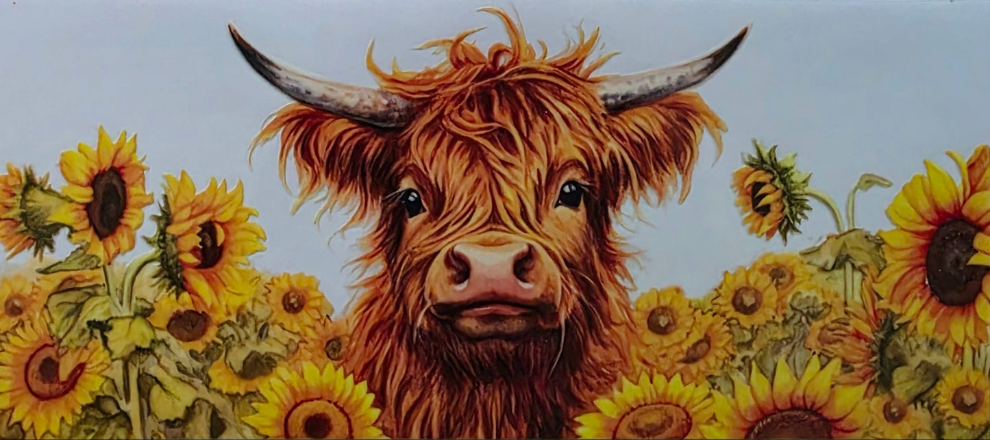 Painting of a highland cow surrounded by sunflowers on a textured surface.