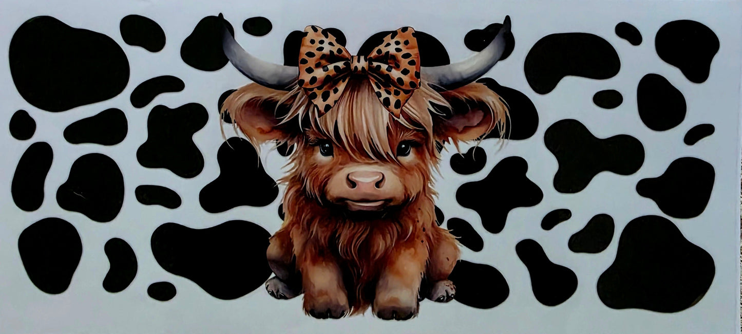Sticker of a Highland cow with a leopard print bow on a white background with black cow pattern.