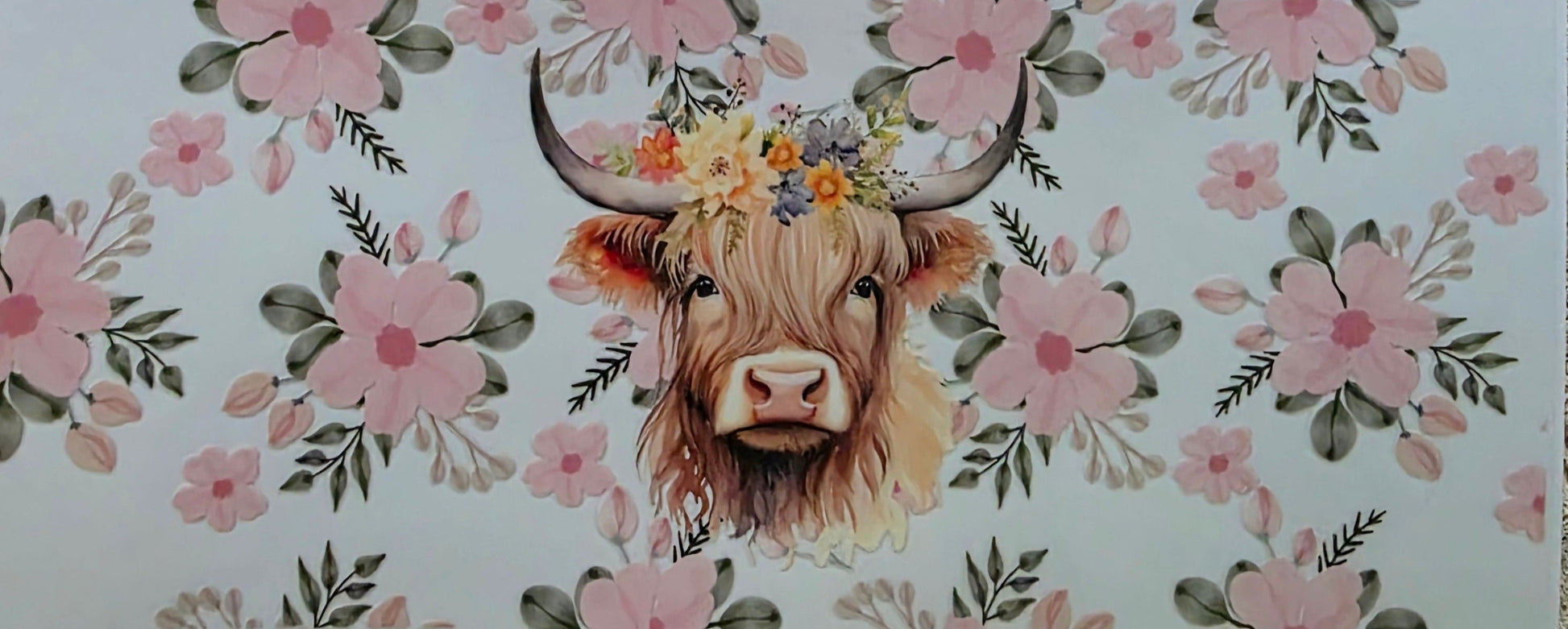 Sticker with a cow's face surrounded by floral patterns on a white background