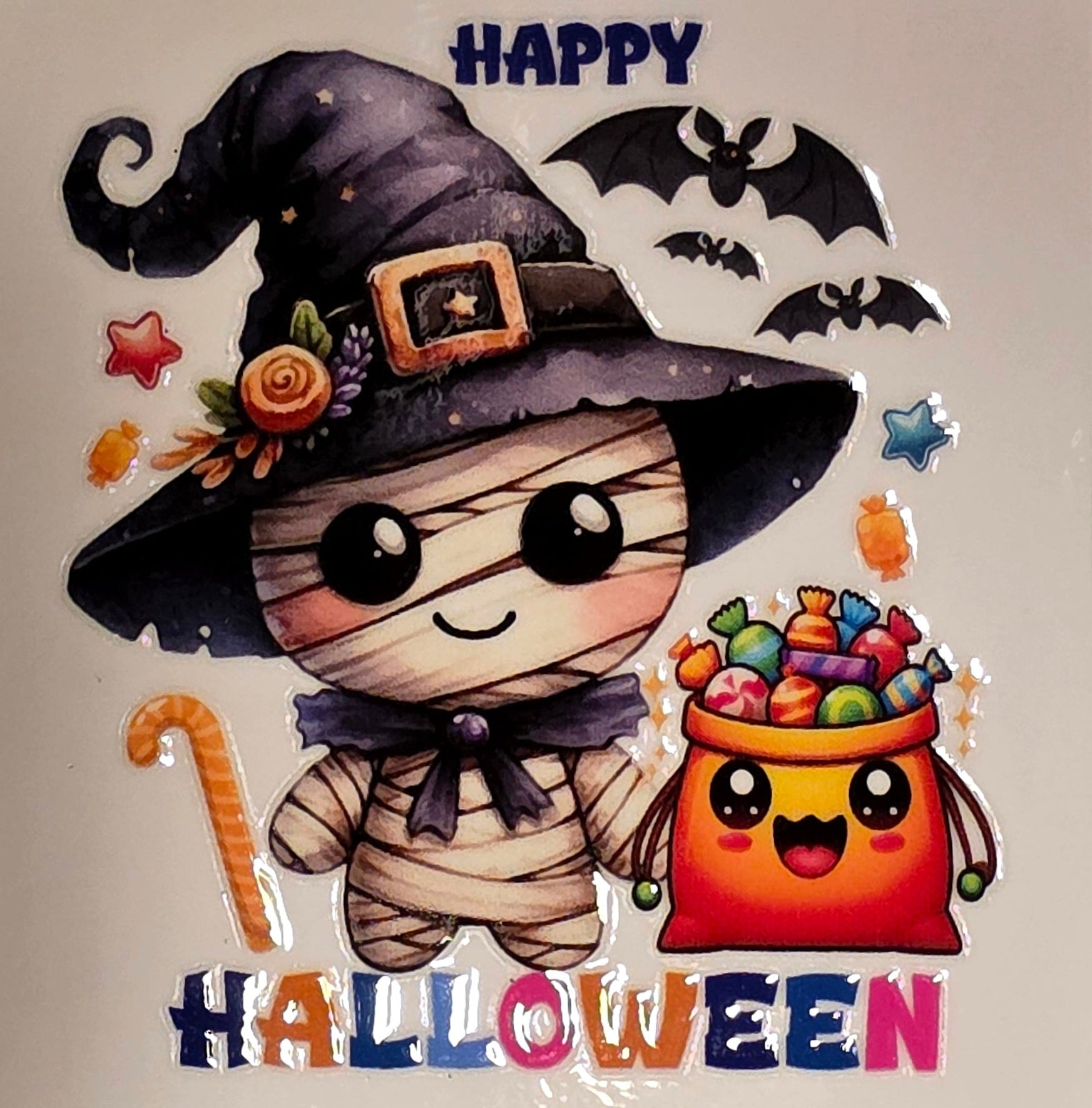 Halloween-themed illustration with a mummy, candy bag, and witch hat on a neutral background.