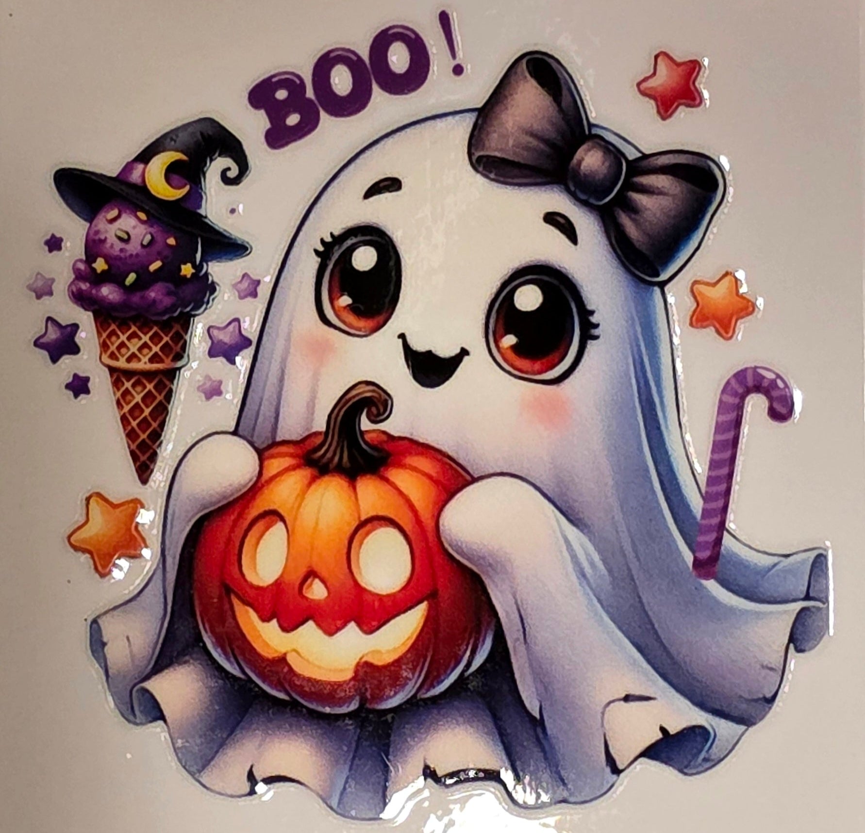 Cartoon ghost holding a pumpkin with 'BOO!' text on a marble background