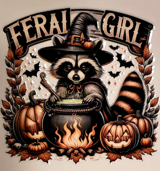 Illustration of a raccoon in a witch hat with 'Feral Girl' text, surrounded by pumpkins and leaves.