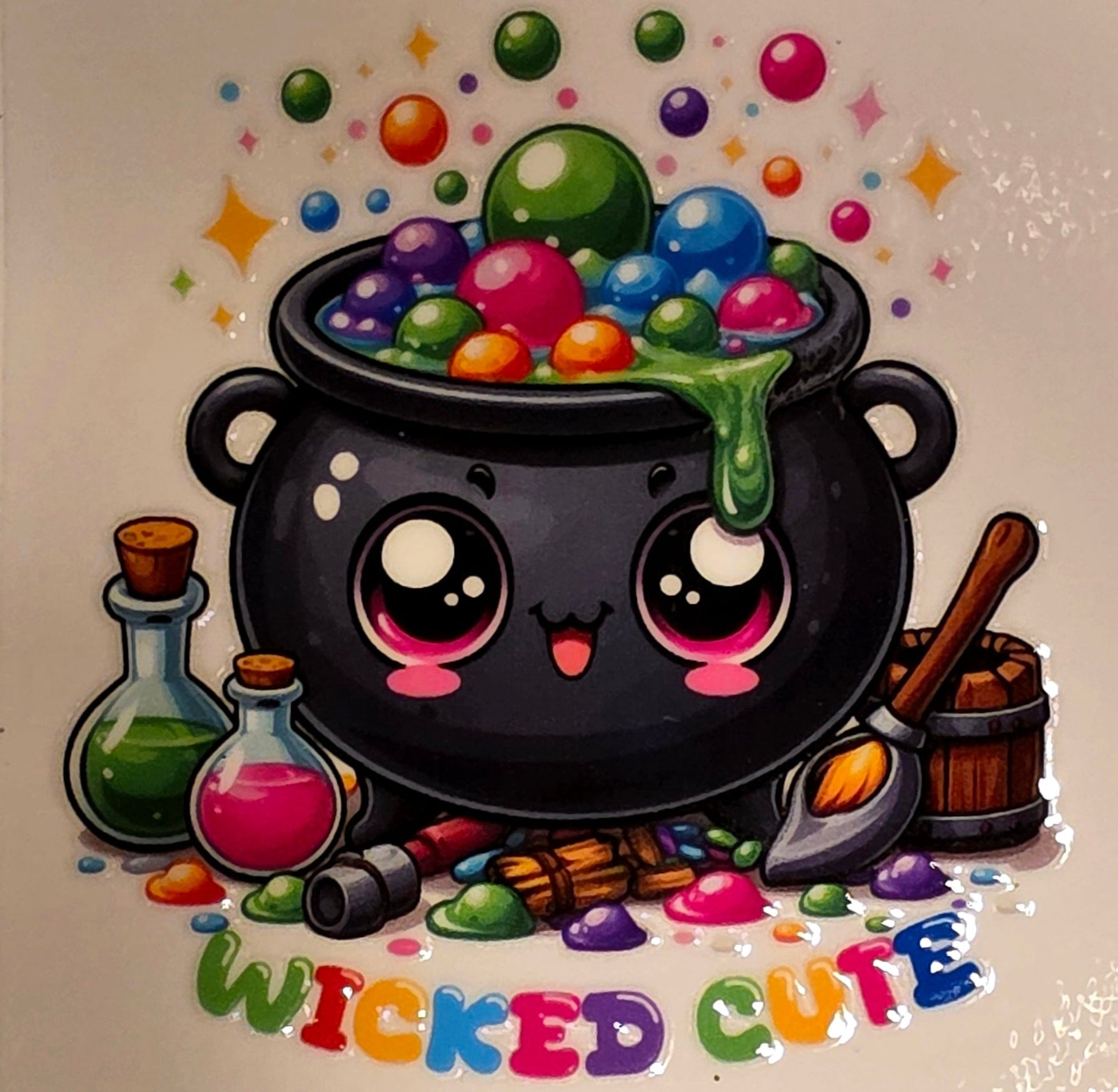 Cartoon cauldron with colorful candies and 'Wicked Cute' text on a marble background