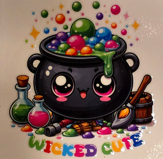 Cartoon cauldron with colorful candies and 'Wicked Cute' text on a marble background